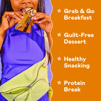 Person holding Magic Spoon protein treat bars with peanut butter and marshmallow flavors visible on packaging.